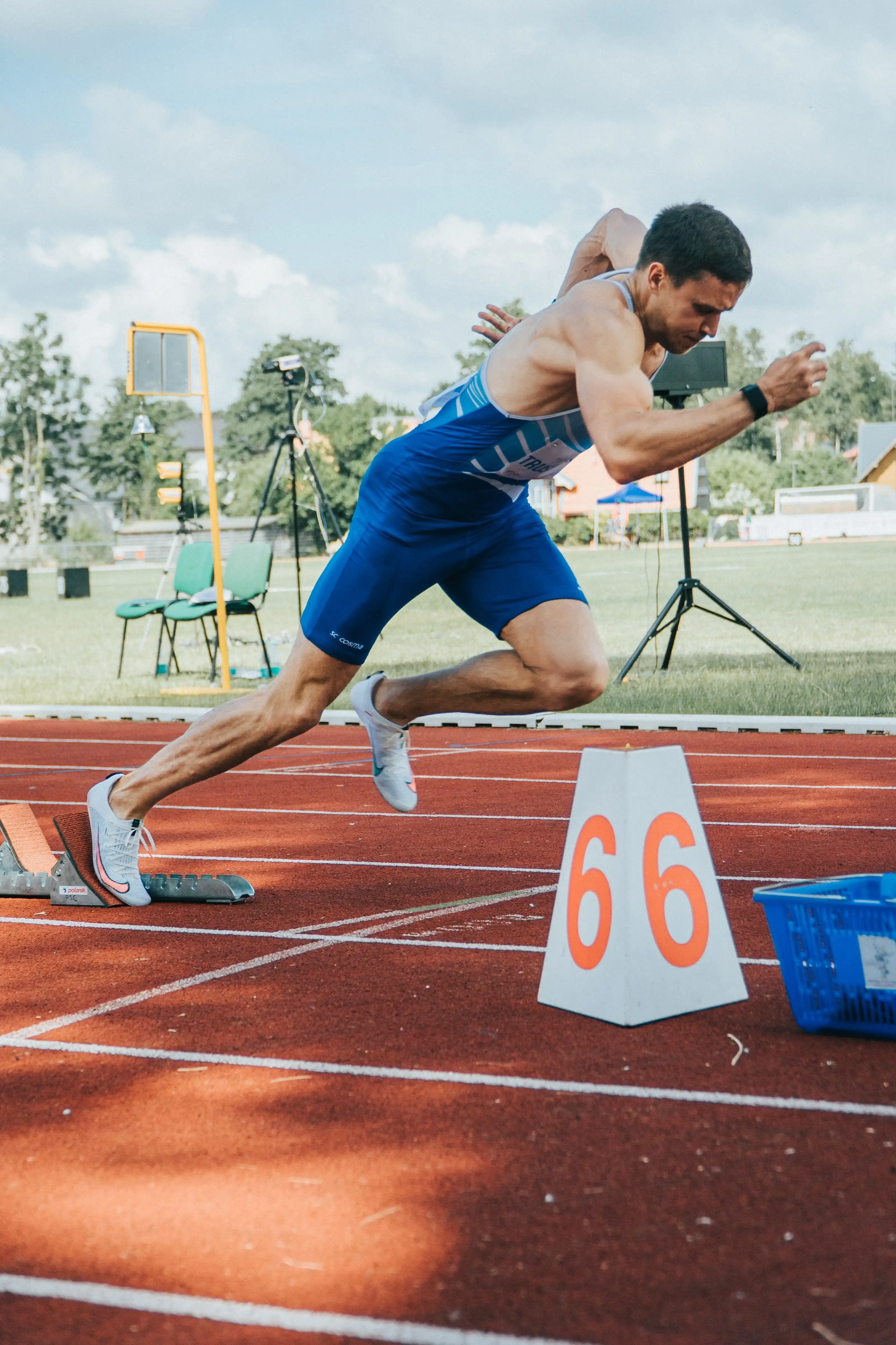 Sprinter exploding out of the starting blocks on a track